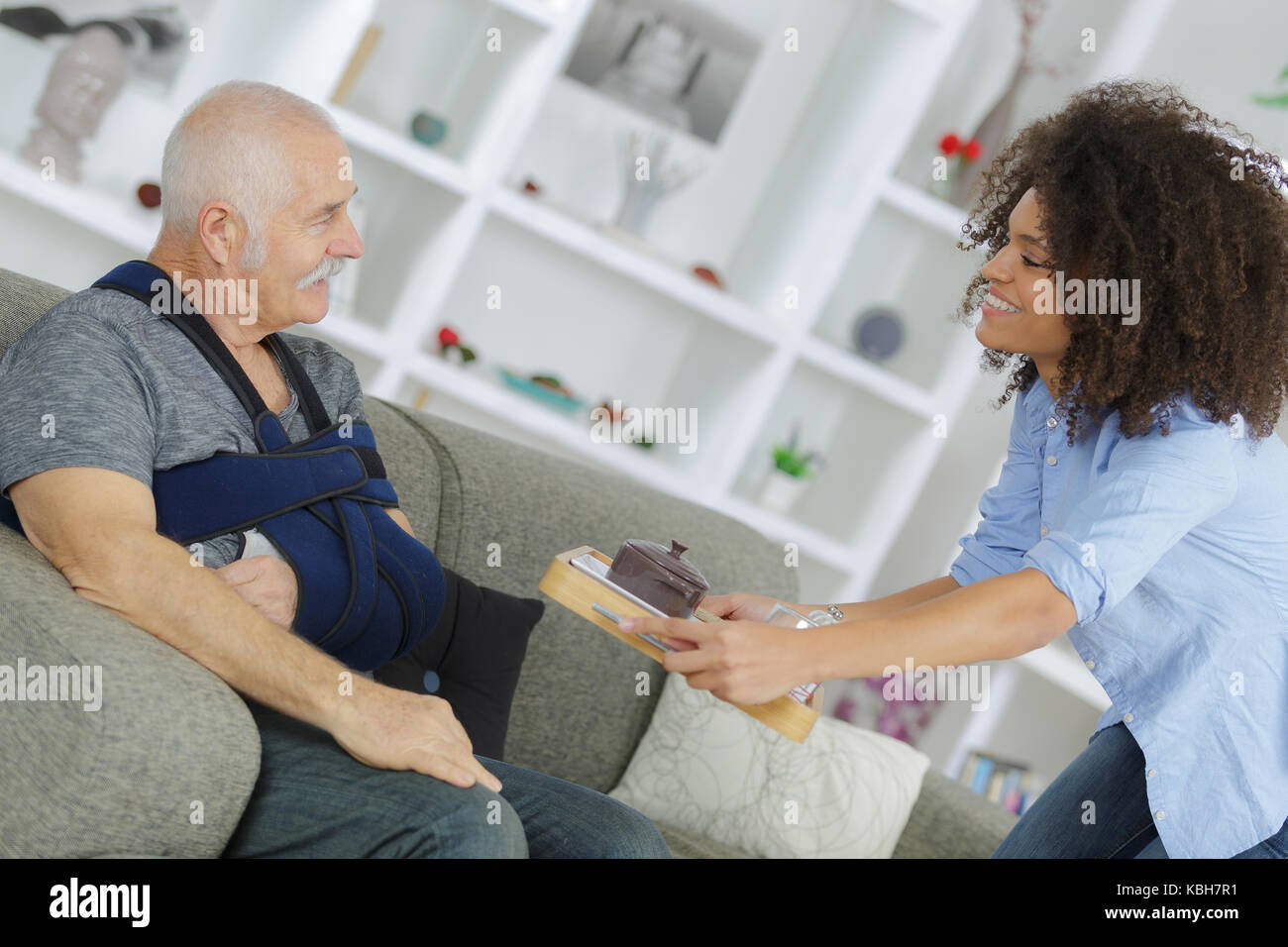 carer giving breakfast to senior patient Stock Photo