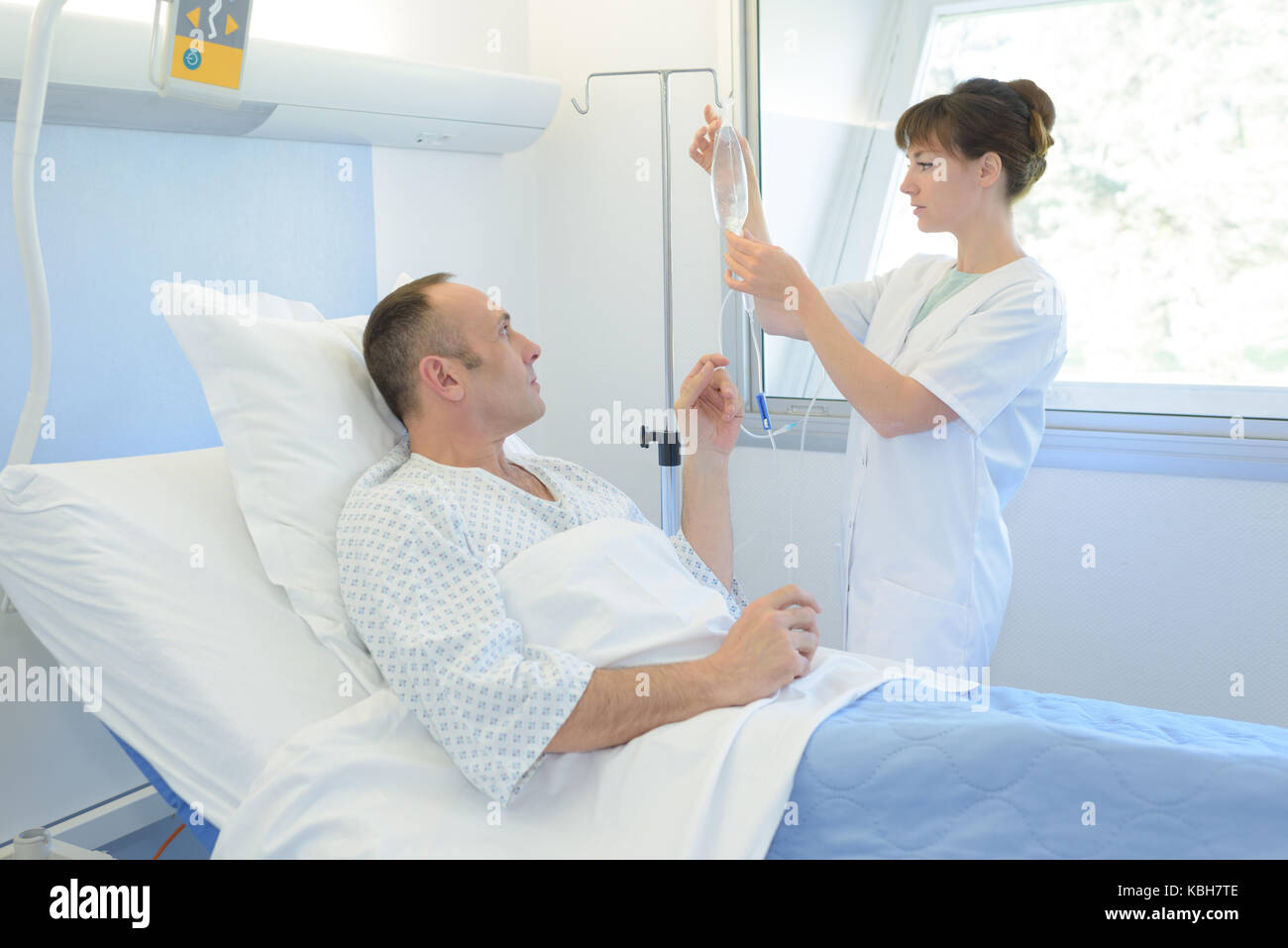 adjusting the IV Stock Photo - Alamy