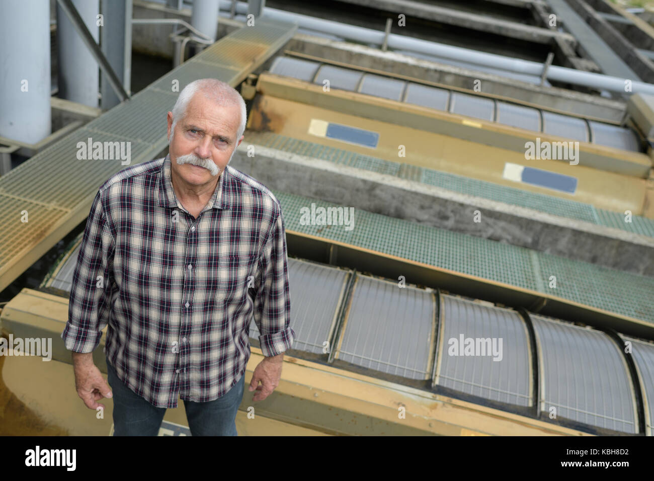 man standing on a factory roof Stock Photo - Alamy