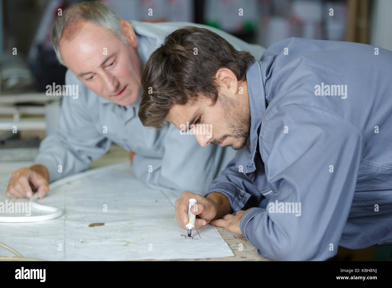 men discussing drawing Stock Photo Alamy