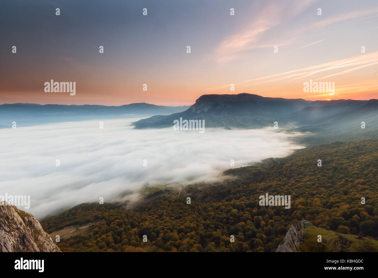 Autumn forest over the clouds in Andia Stock Photo