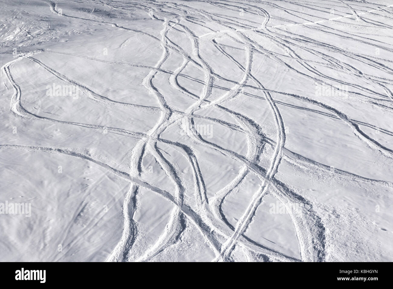 Offpiste ski slope with trace from skis and snowboards at sun winter