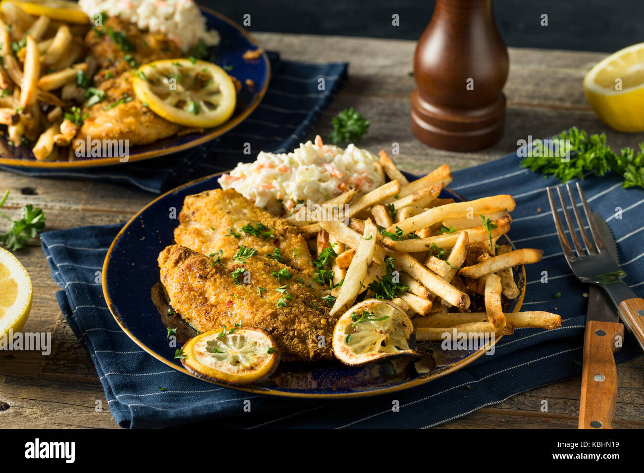 Spicy Homemade BAked  Cajun Catfish with French Fries Stock Photo