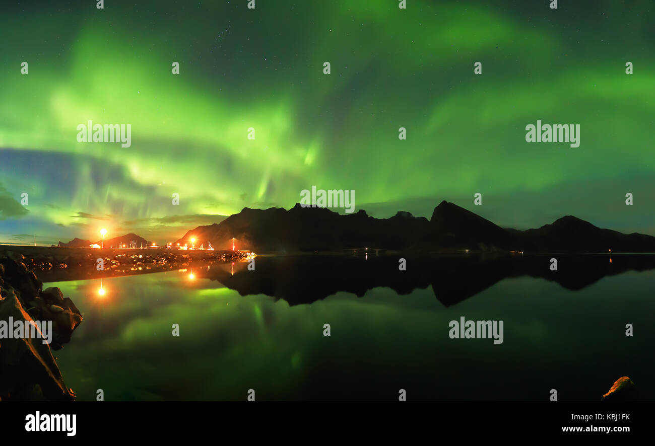 Northern lights over fjord. Night landscape of northern lights. Stock Photo