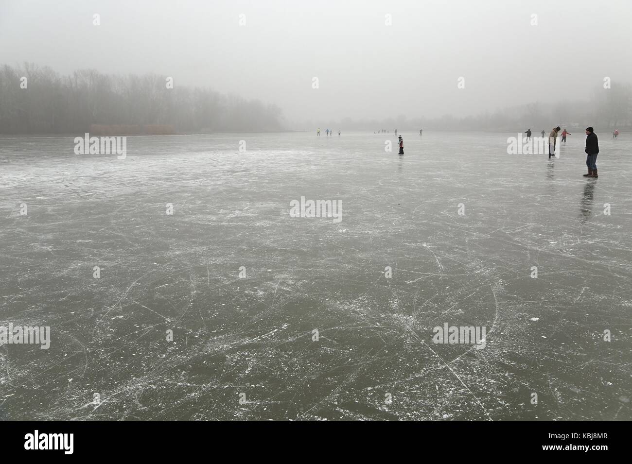 Skating on frozen lake Stock Photo - Alamy
