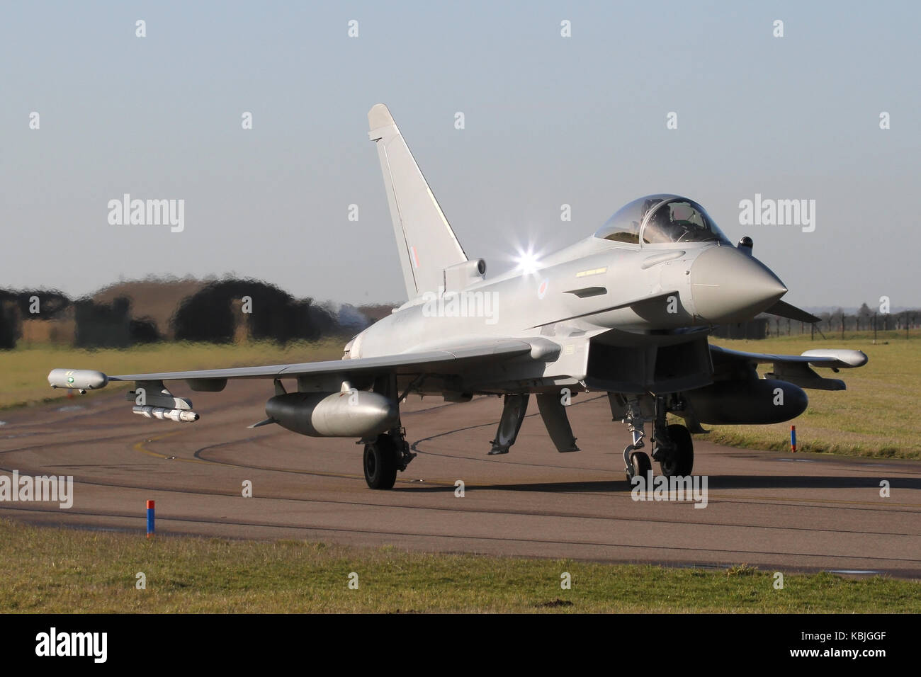 Lucky catch of the strobe light on this RAF Eurofighter Typhoon FGR4 taxiing for the active runway at RAF Coningsby on a clear winters day. Stock Photo