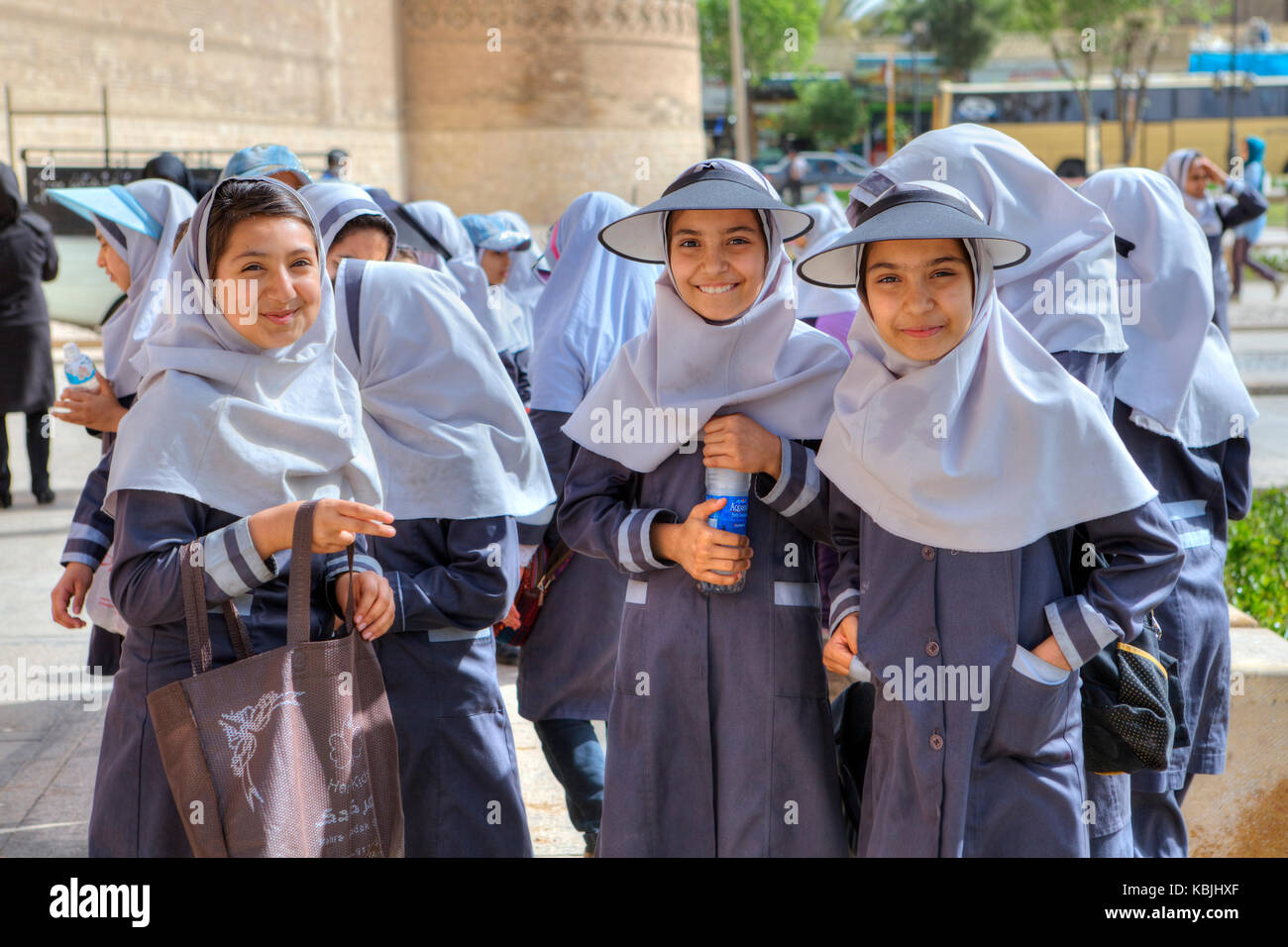 Fars Province, Shiraz, Iran - 19 april, 2017: Portrait of three Iranian schoolgirls in school uniform with a hijab and head visor. Stock Photo