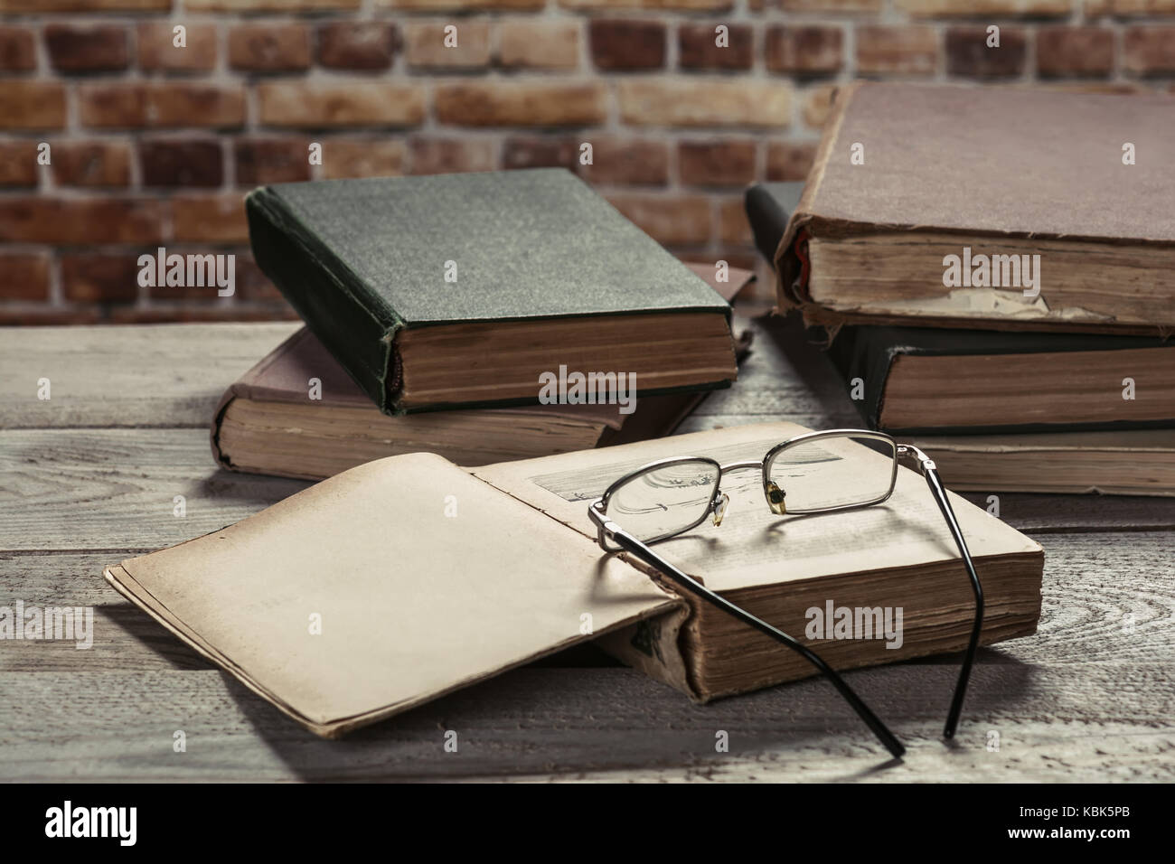 Old books on wooden table Stock Photo - Alamy