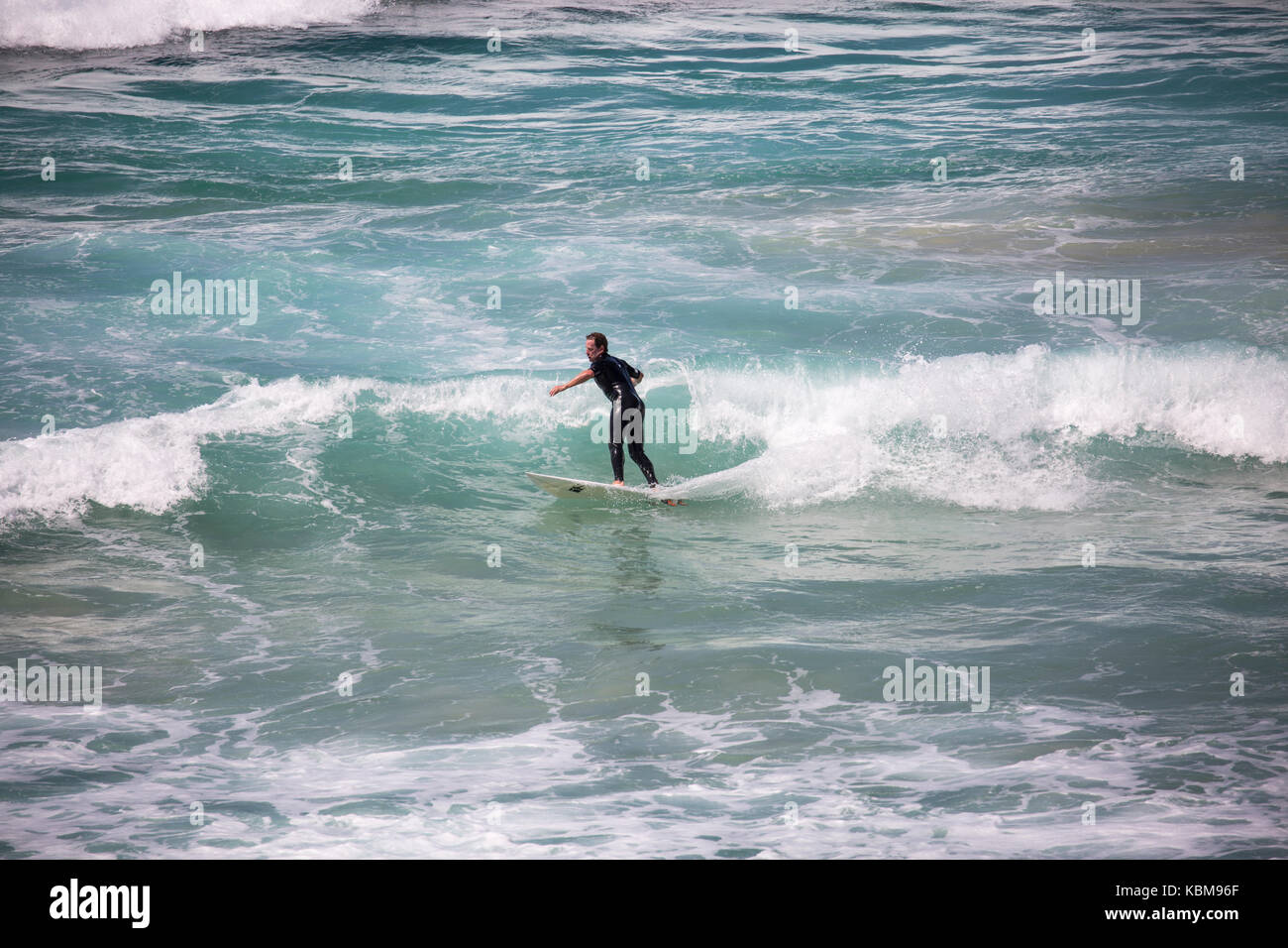 Man surfing in the ocean at One Mile beach in Forster on the new south