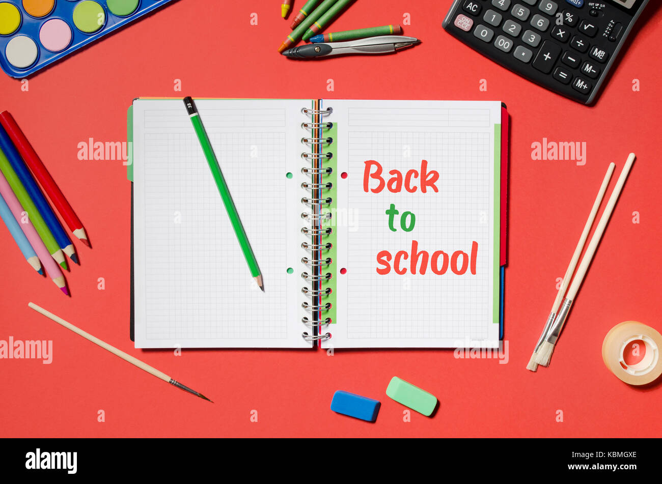 Notepad with back to school words and office stationery, red background.  stationery office desk top view table school student concept Stock Photo