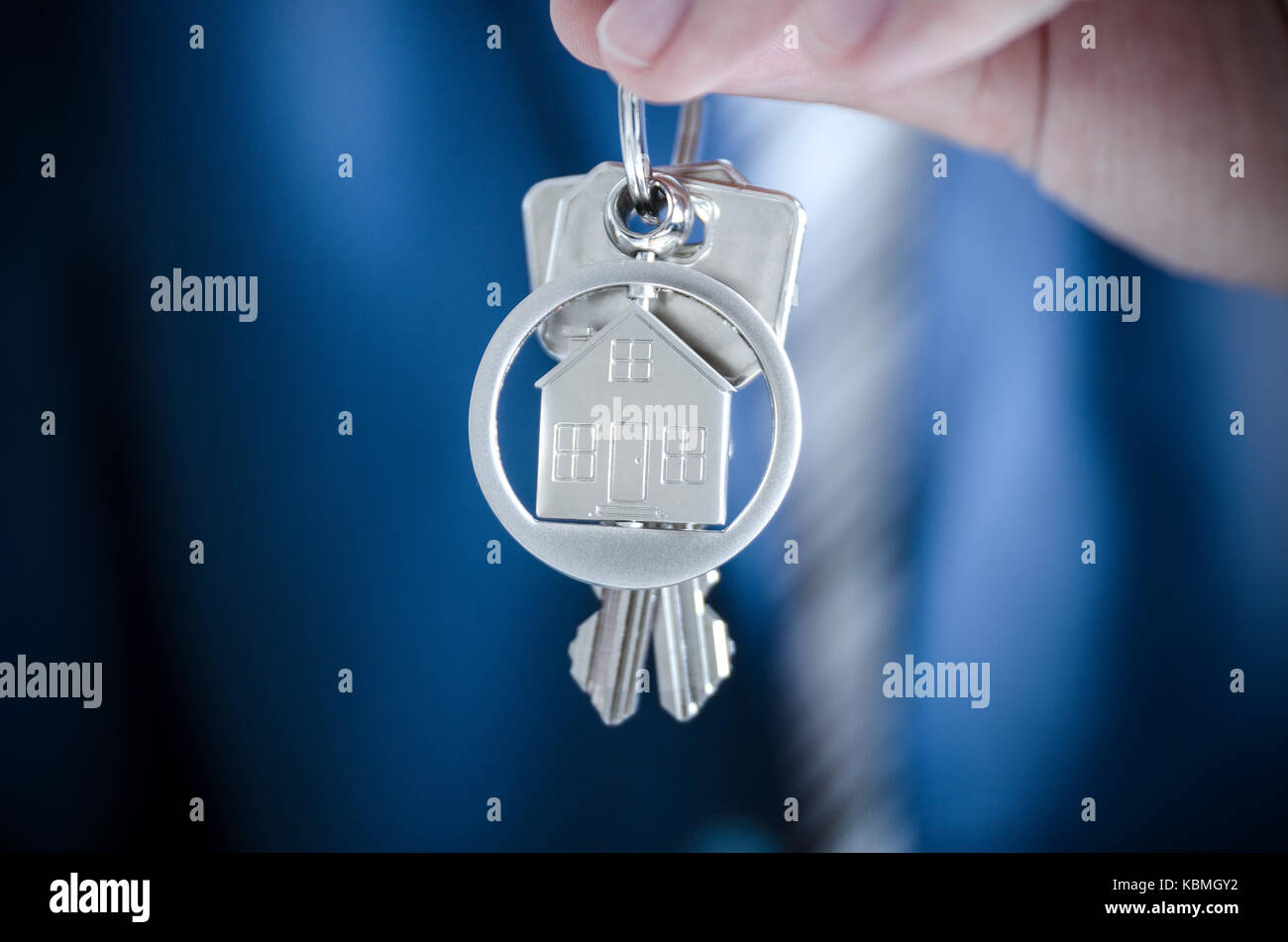 Real estate agent holding key of new apartment close up. realestate key real estate house security home deal concept Stock Photo