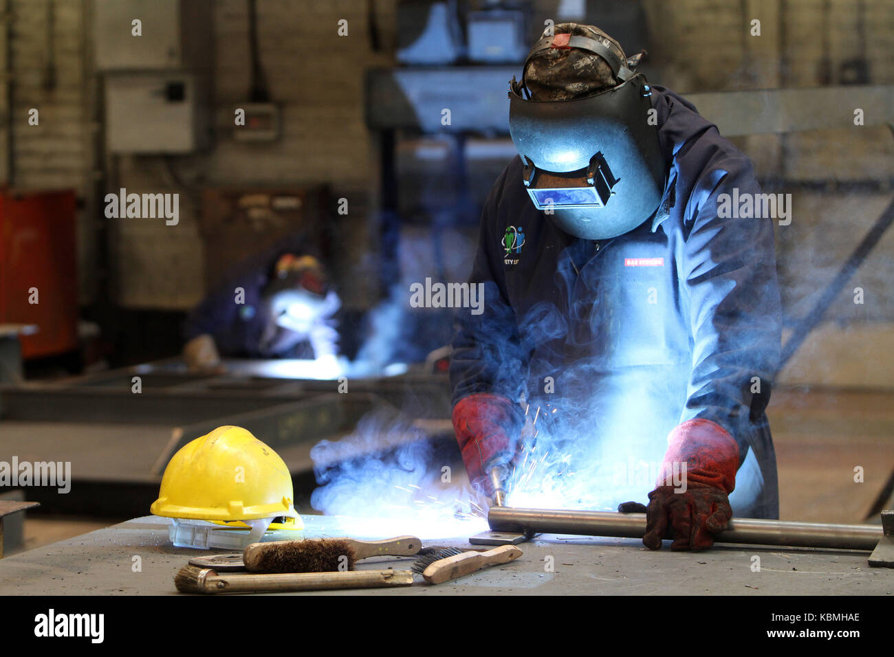 tradesman welding in shipyard Stock Photo