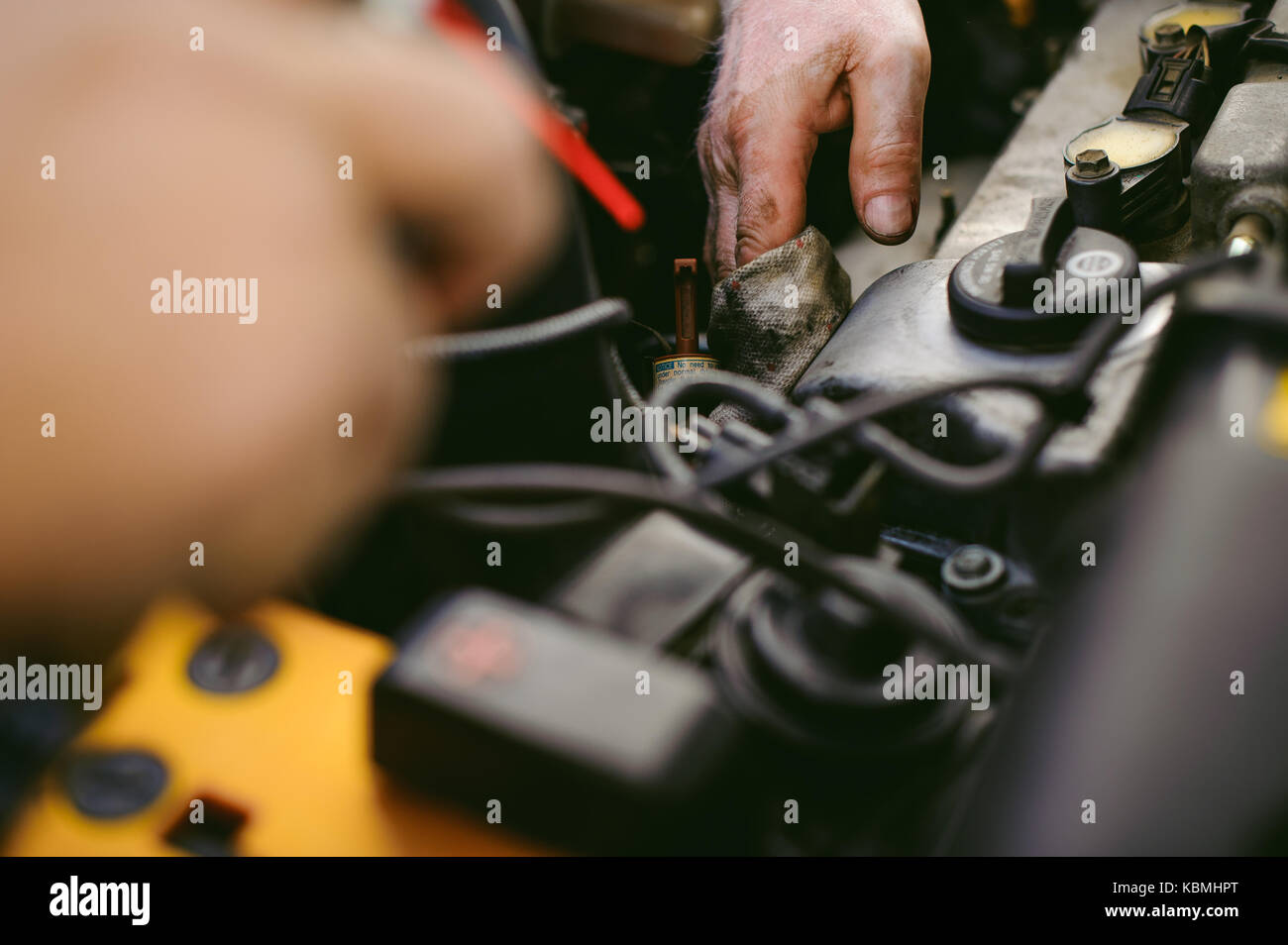 hands of an auto mechanic close-up. servicing and caring for a car engine Stock Photo