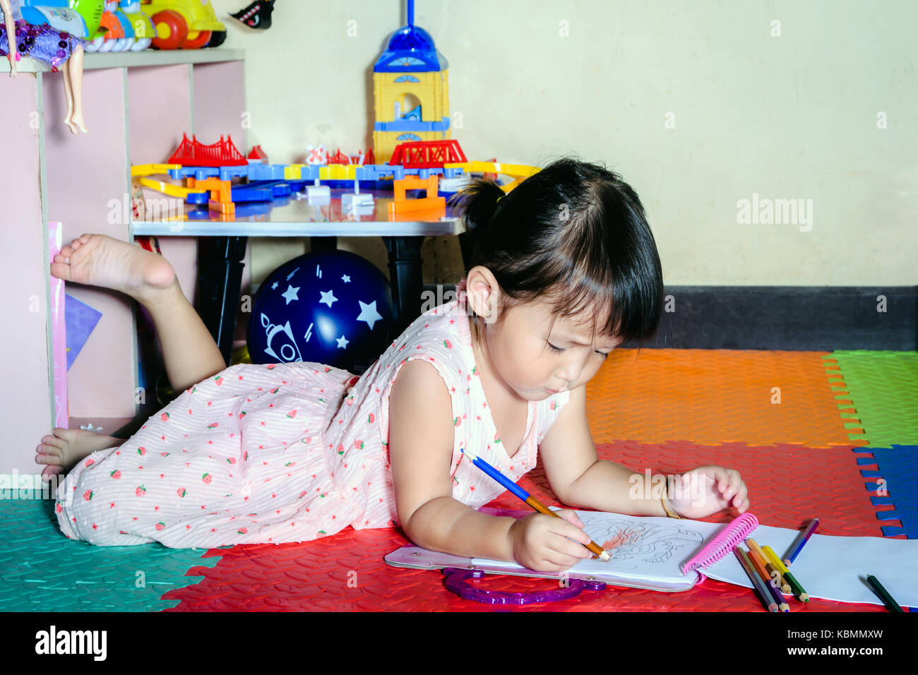 Little child painting with colorful pencils indoors at home Stock Photo