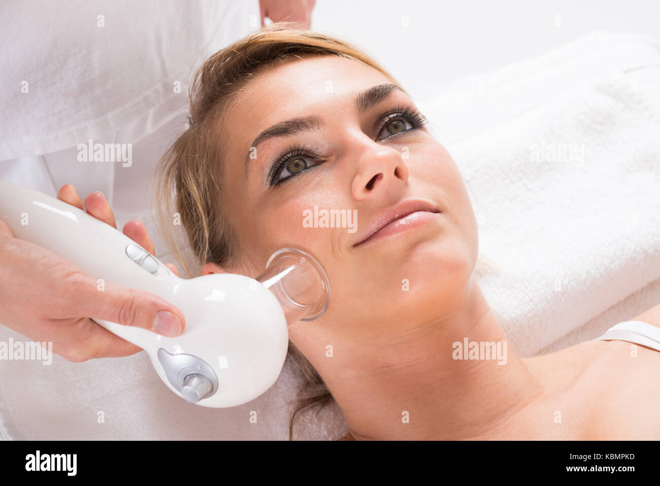 High angle view of young woman receiving cellulite vacuum therapy on