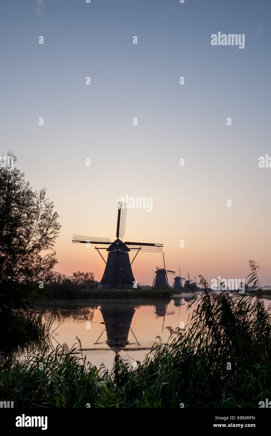 fog near the windmills in Kinderdijk in Holland Stock Photo