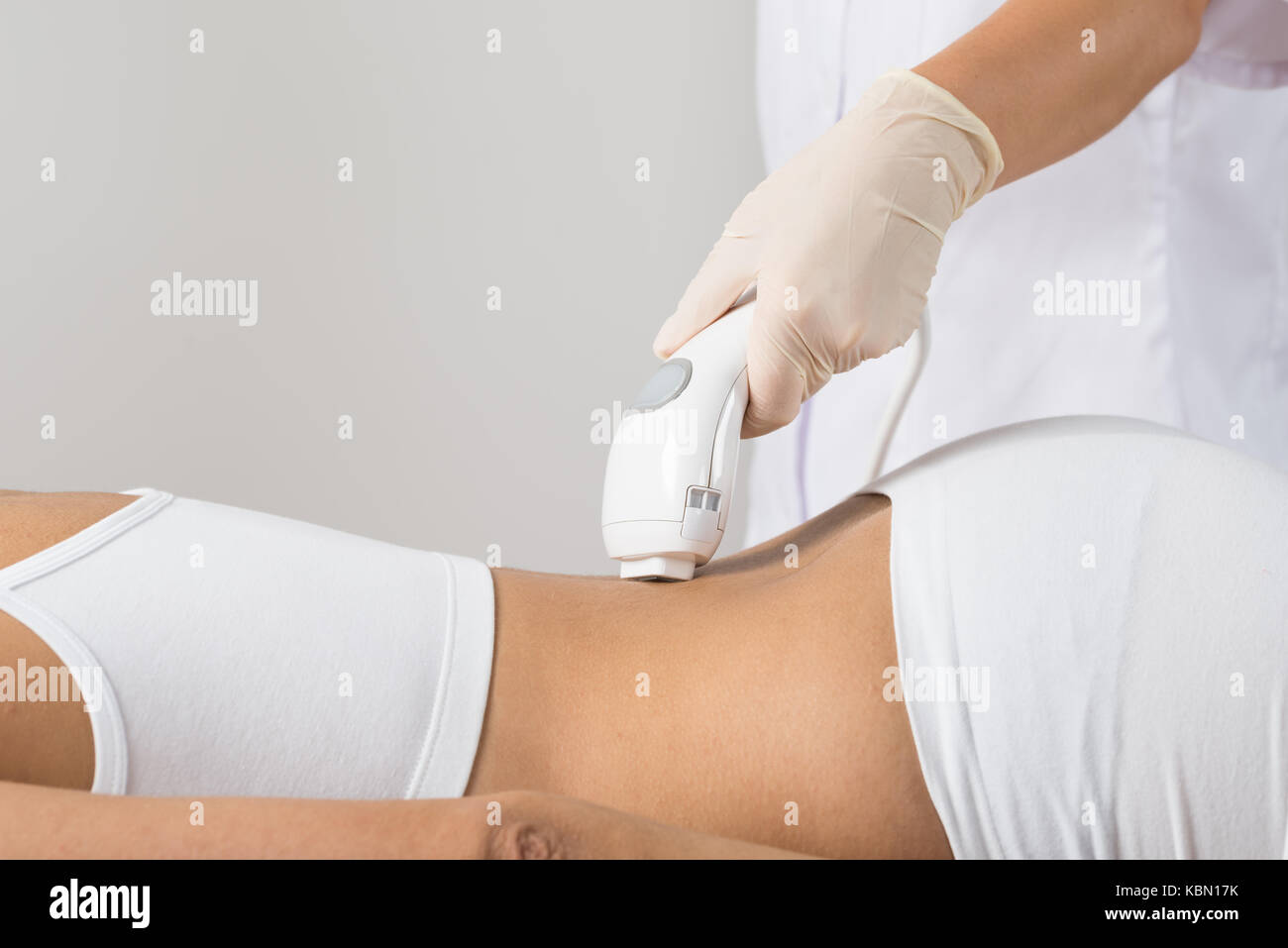 Close-up Of Woman Lying Receiving Epilation Laser Treatment On Back Stock Photo