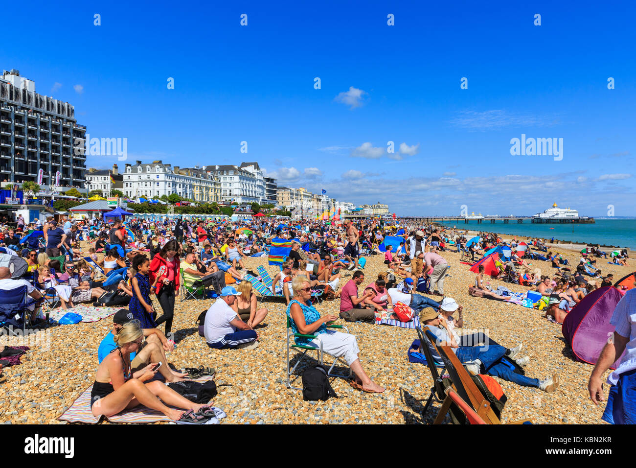 Families, people on busy and crowded Eastbourne beach on a hot and