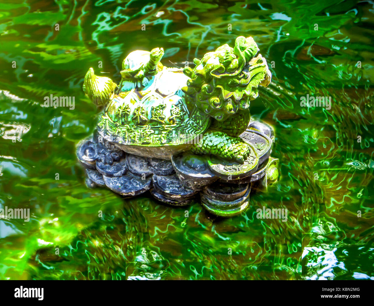 gold green dragon turtle Pixiu at pool and water mirror surface
