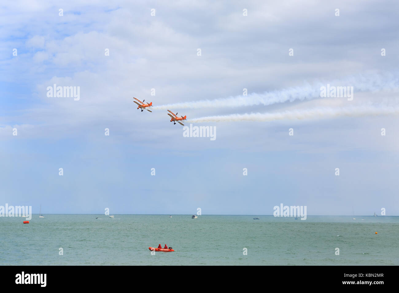 Breitling Wingwalkers aerobatics and wingwalking team  over the sea, part of Airbourne, Eastbourne Air show 2017, UK Stock Photo