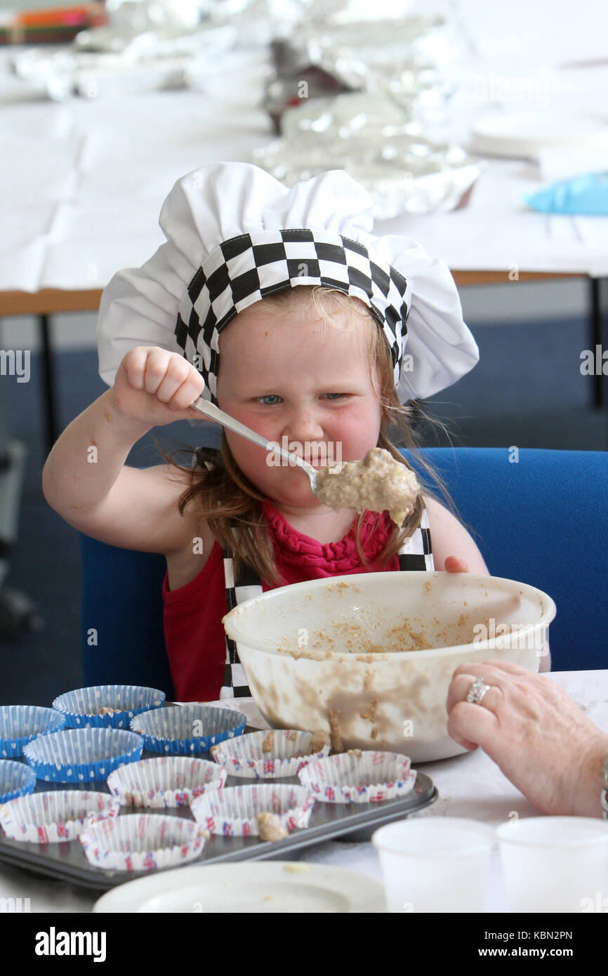 Young girl learning to cook Stock Photo