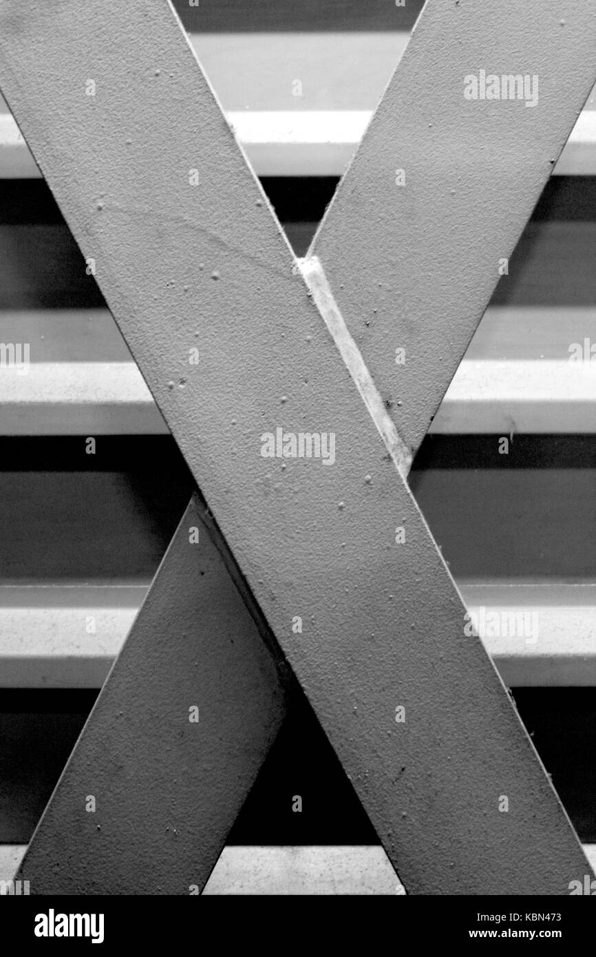 Formalist Photography. Simple black and white photograph of metal industrial architecture featuring a simple metal cross over horizontal bars. Stock Photo