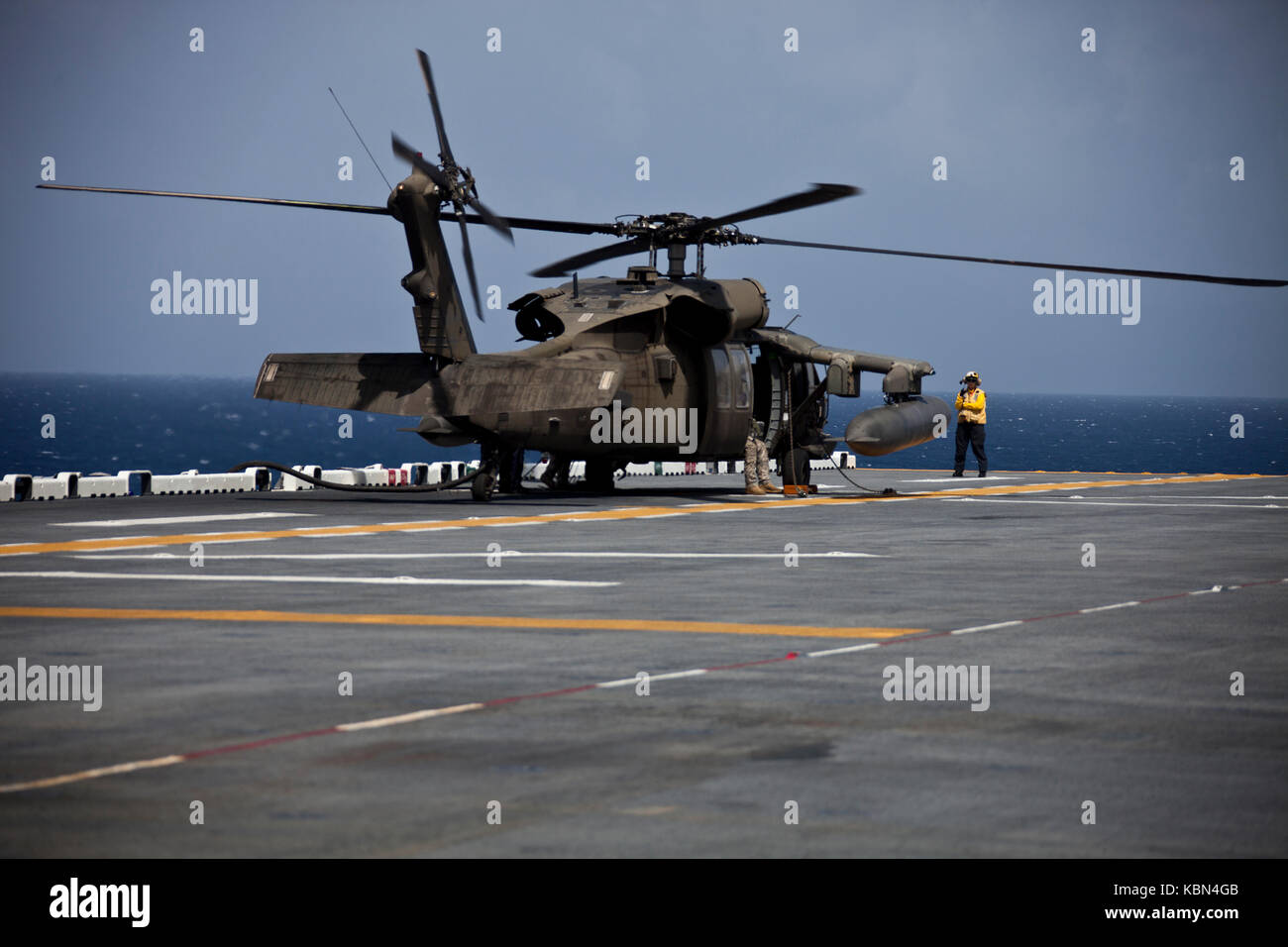 U.S. Army UH-60 Black Hawk helicopter with Joint Task Force - Leeward Islands continues its mission after refueling on the USS Wasp (LHD-1) Stock Photo