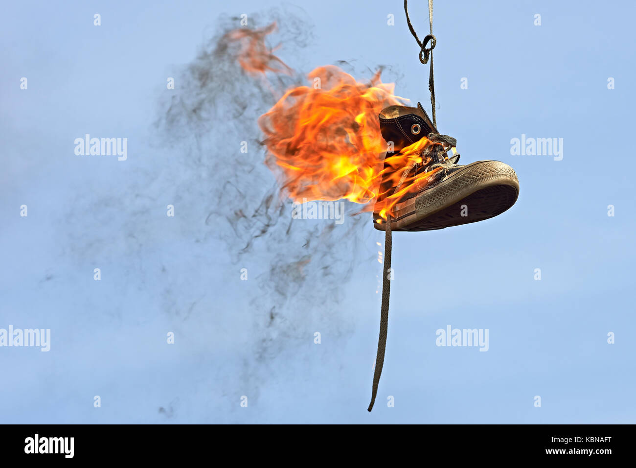 Burning converse against a blue sky Stock Photo - Alamy