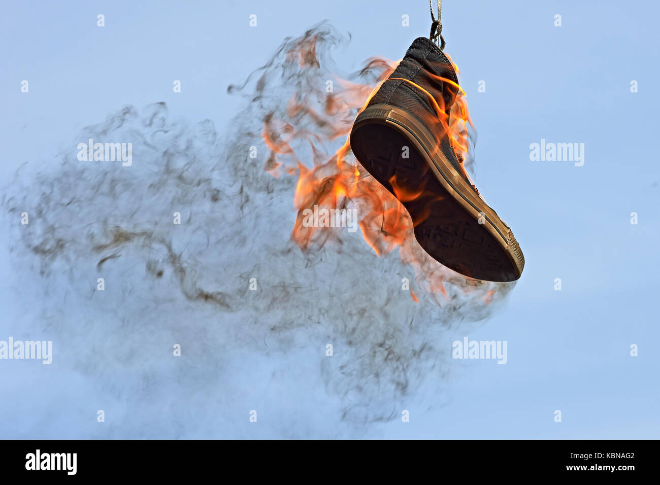 Burning converse against a blue sky Stock Photo - Alamy