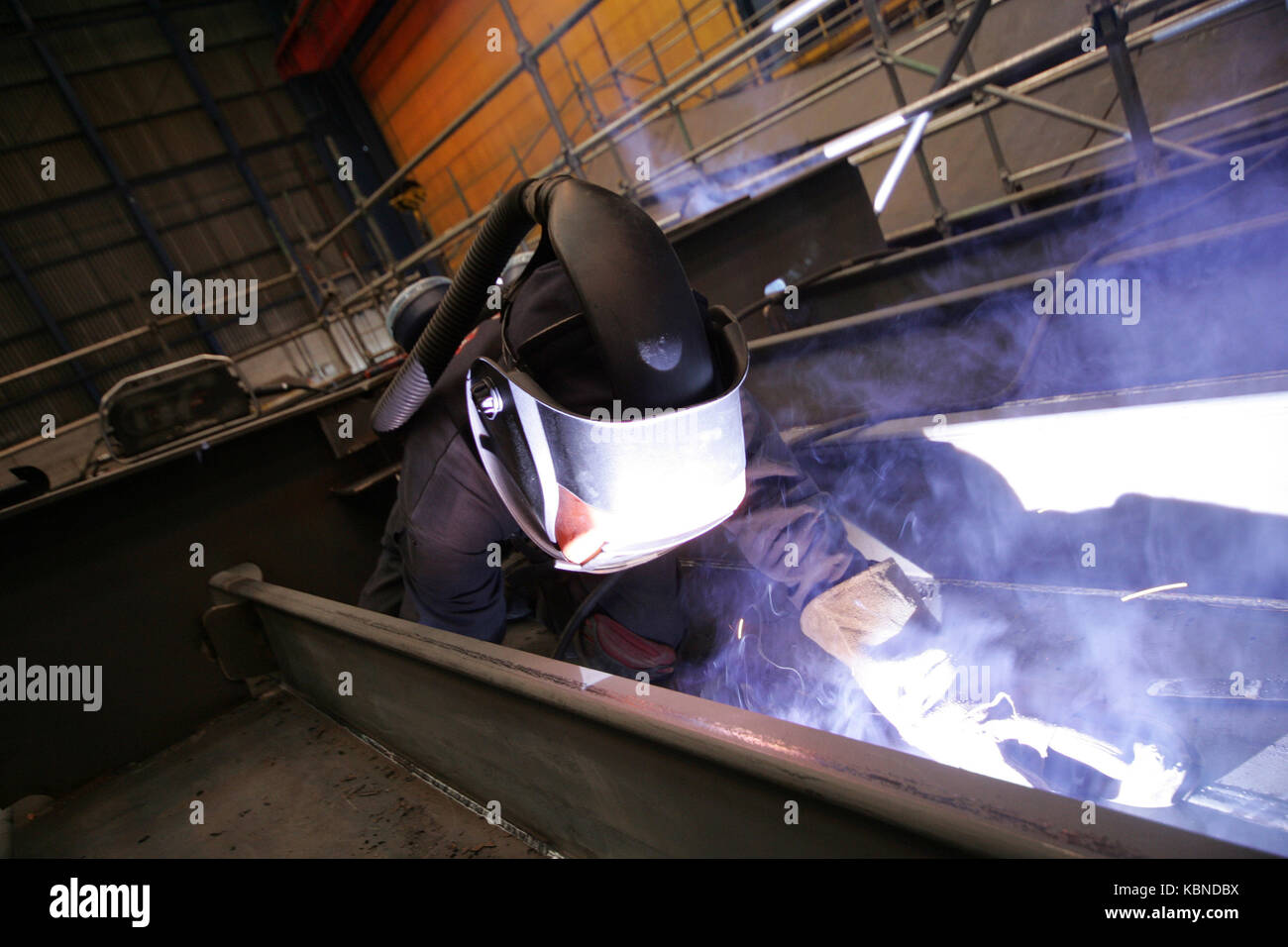 tradesman welding in shipyard Stock Photo