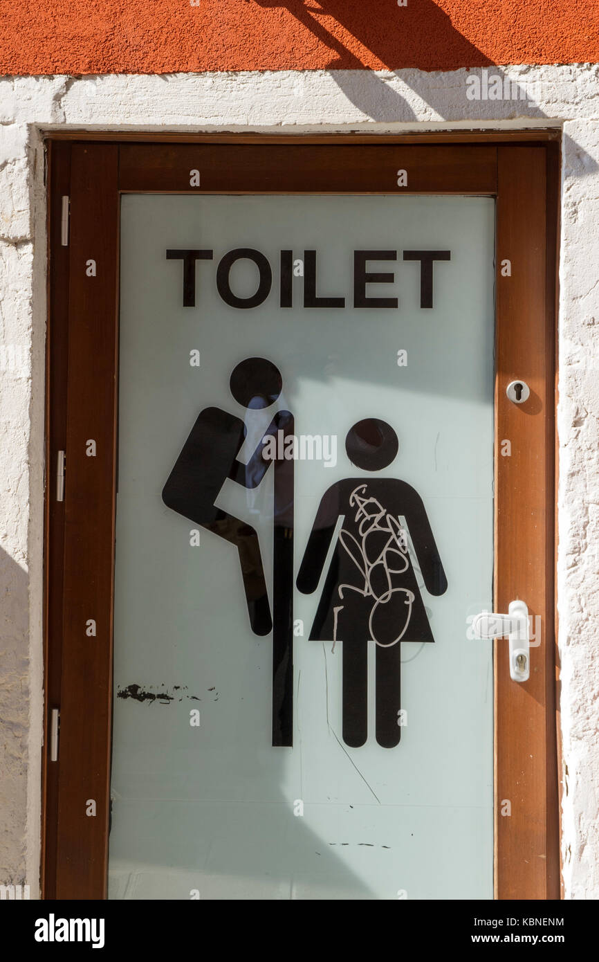 A sign warning of a peeping Tom in a toilet Stock Photo
