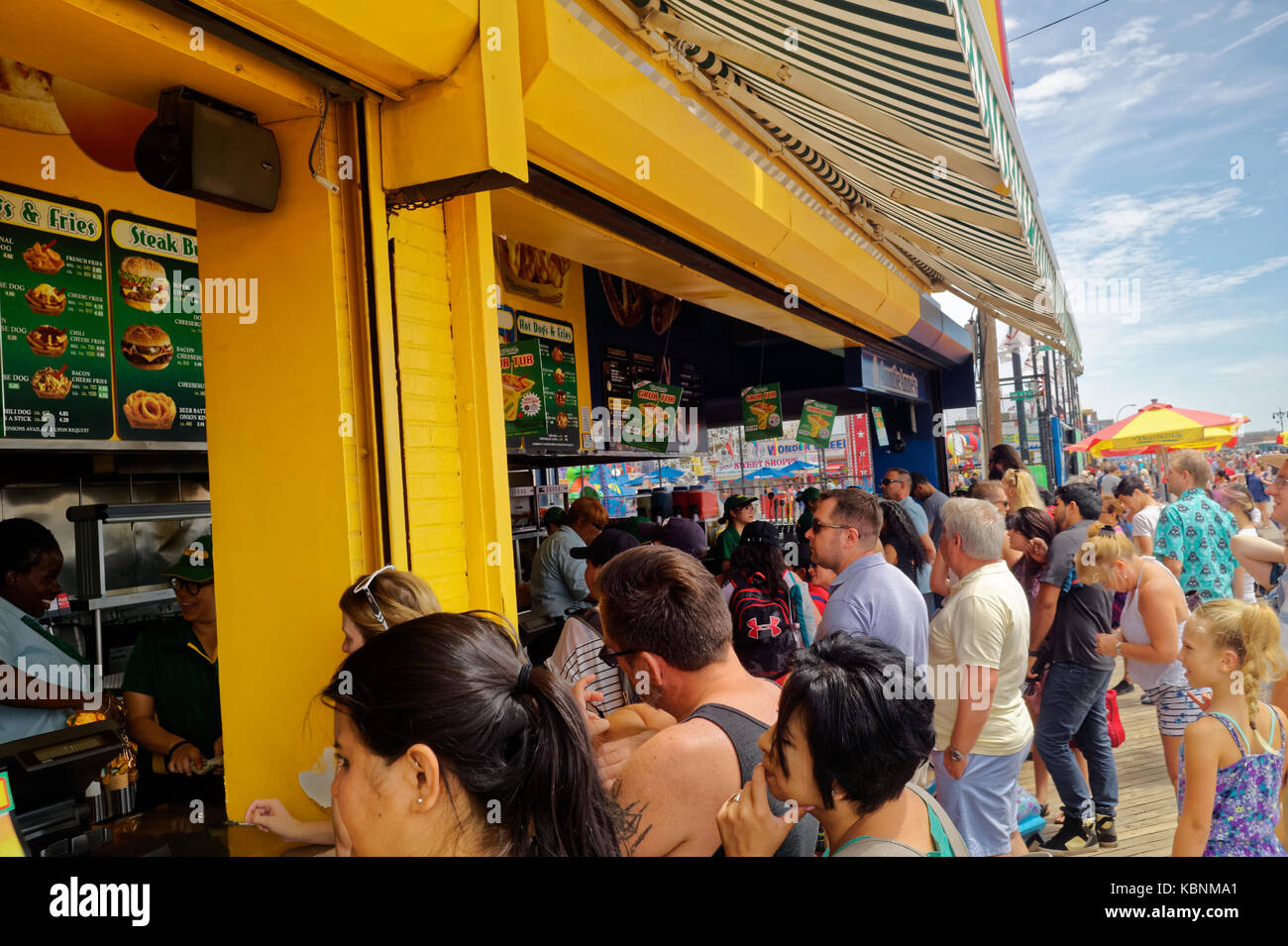 Line of visitors and tourists at Nathan's Famous restaurant on the Coney Island boardwalk. Stock Photo