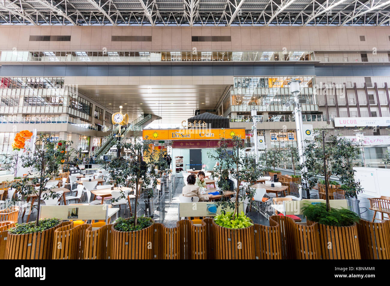 Japan, Osaka, Umeda. Osaka station city, interior, Del Sole cafe bar on main upper concourse. People sitting at tables, drinking and chatting. Stock Photo