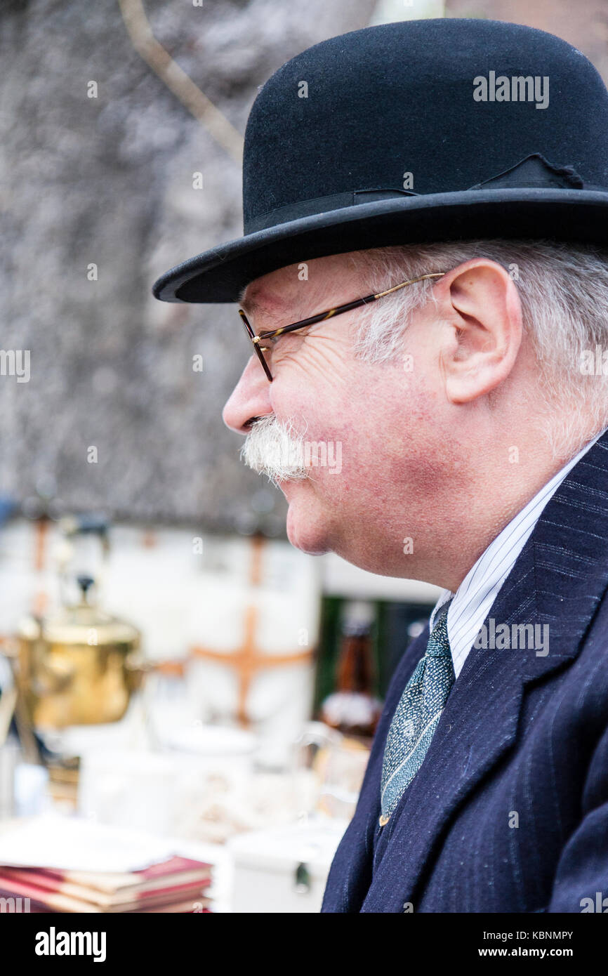 England, Chatham. Re-enactment. Elderly man with grey moustache and glasses, wearing black bowler hat. Side-view. Circa 1940s. Head and shoulders. Stock Photo
