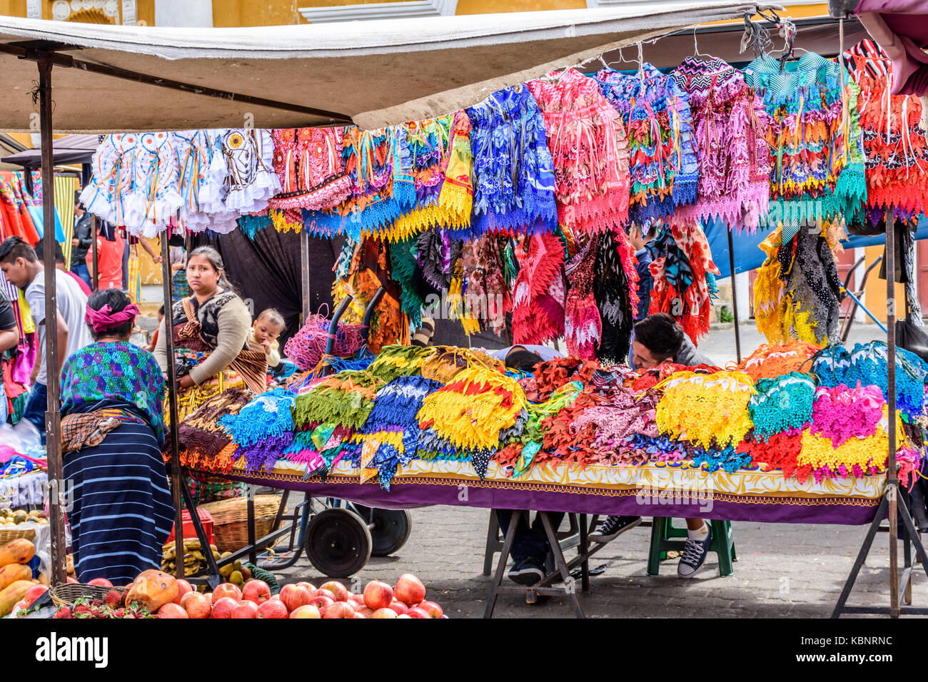 Santa Maria de Jesus, Guatemala - August 20, 2017: Sunday market stall selling colorful aprons in small indigenous town on slopes of Agua volcano Stock Photo