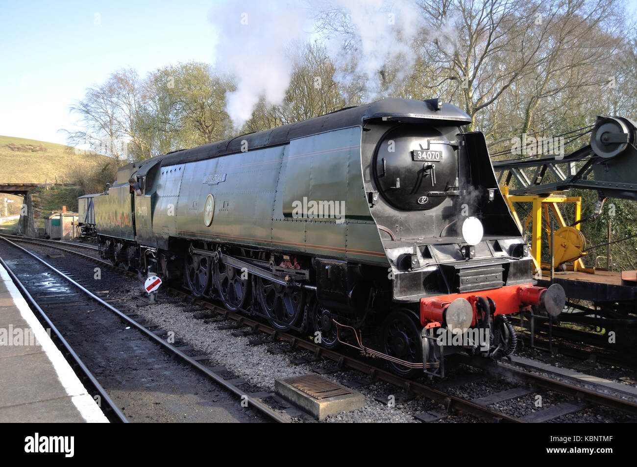 Preserved Battle of Britain Pacific no. 34070 Manston runs round its train at Norden Station on the Swanage Railway in Dorset. Stock Photo