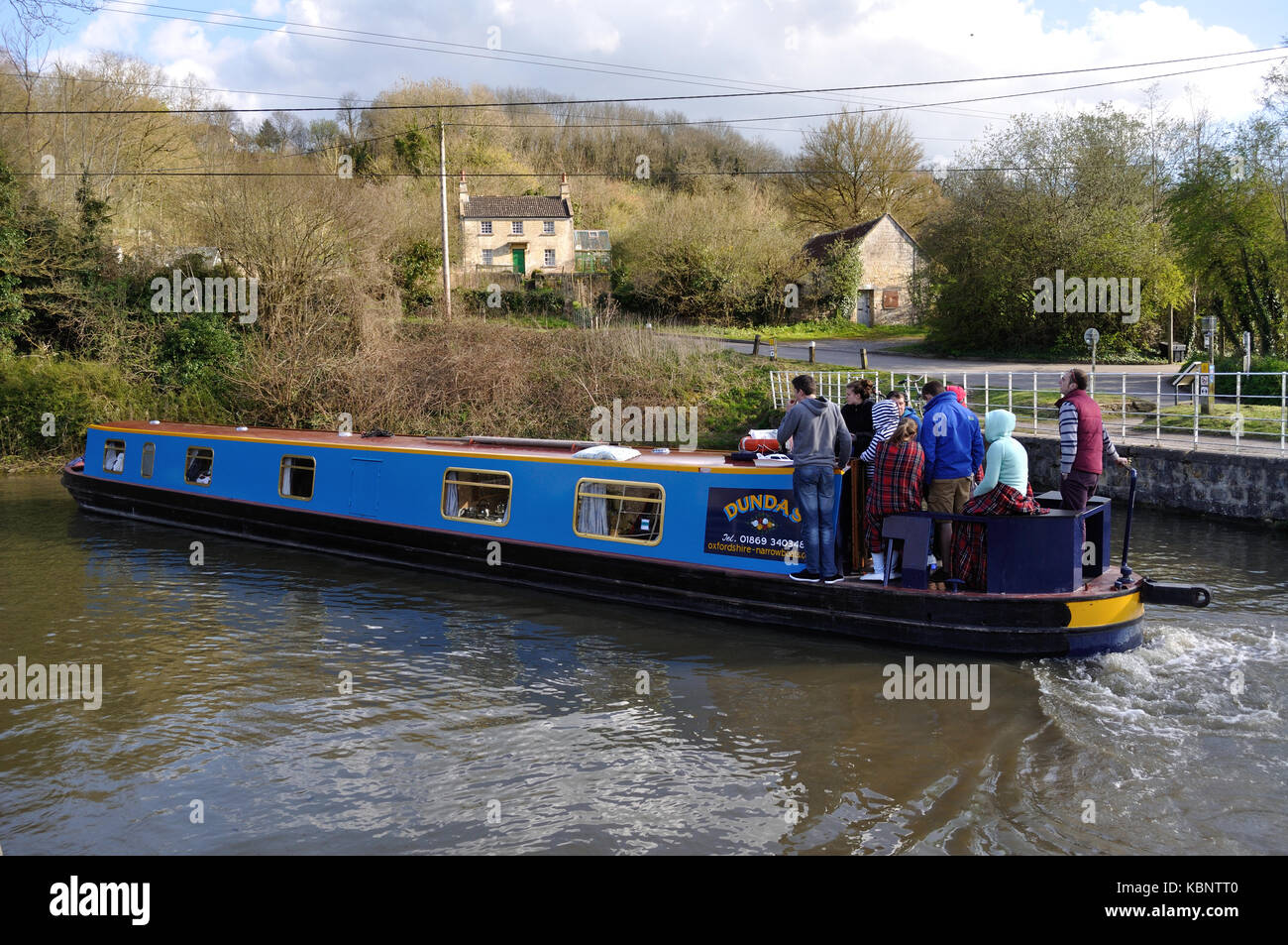 A narrowboat negotiates a sharp bend on the Kennet and Avon Canal at Avoncliff, Wiltshire. Stock Photo