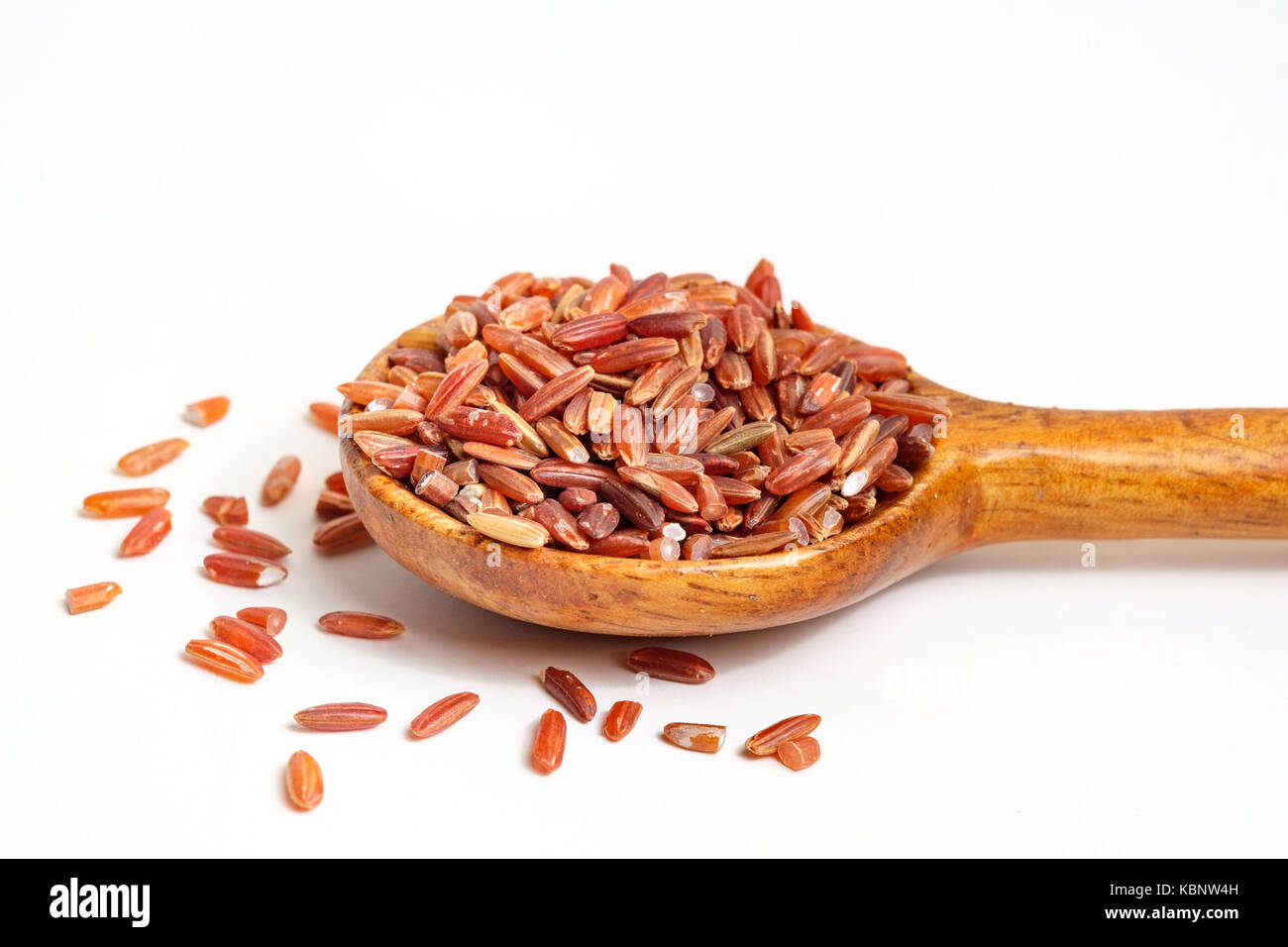 Red rice on wooden spoon Stock Photo