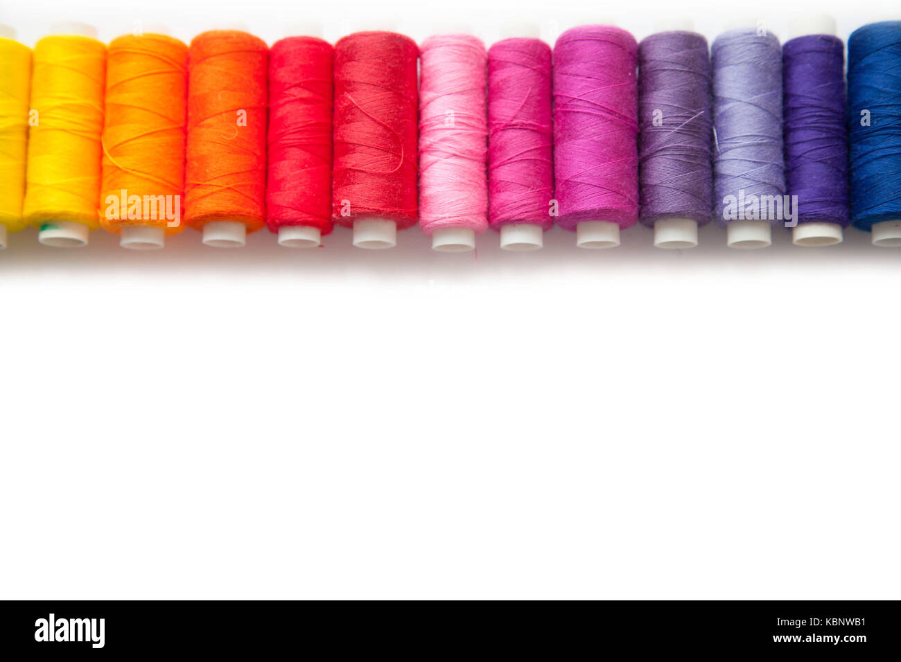 Color thread for sewing. White background Stock Photo - Alamy