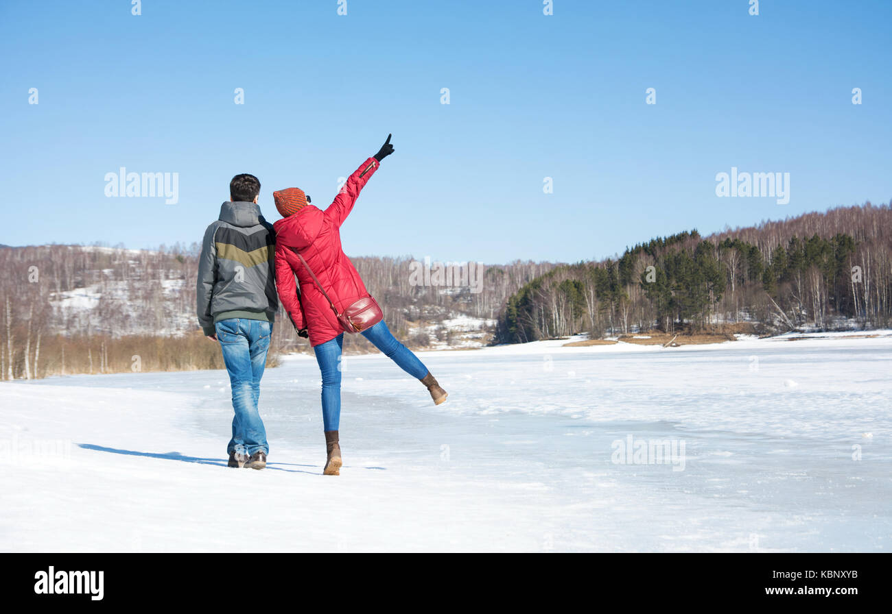 Couple walking on a frozen lake surface Stock Photo - Alamy