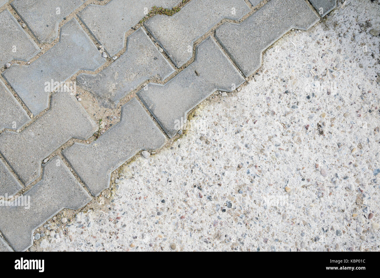 Joint of Concrete and Paving Stones from the Sidewalk. Paving stones on