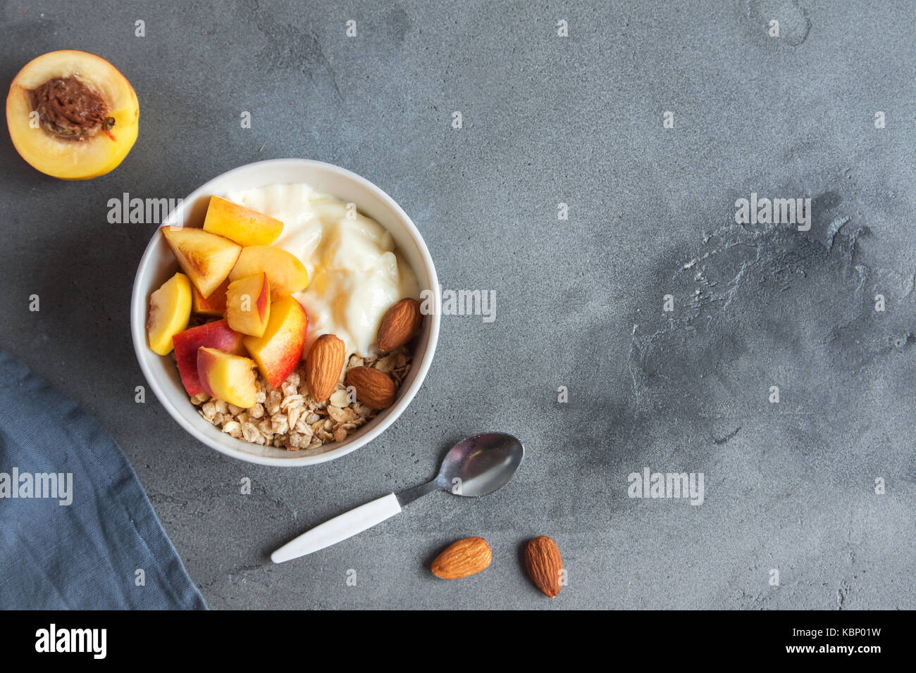Homemade oatmeal granola with yogurt and peaches in bowl for healthy