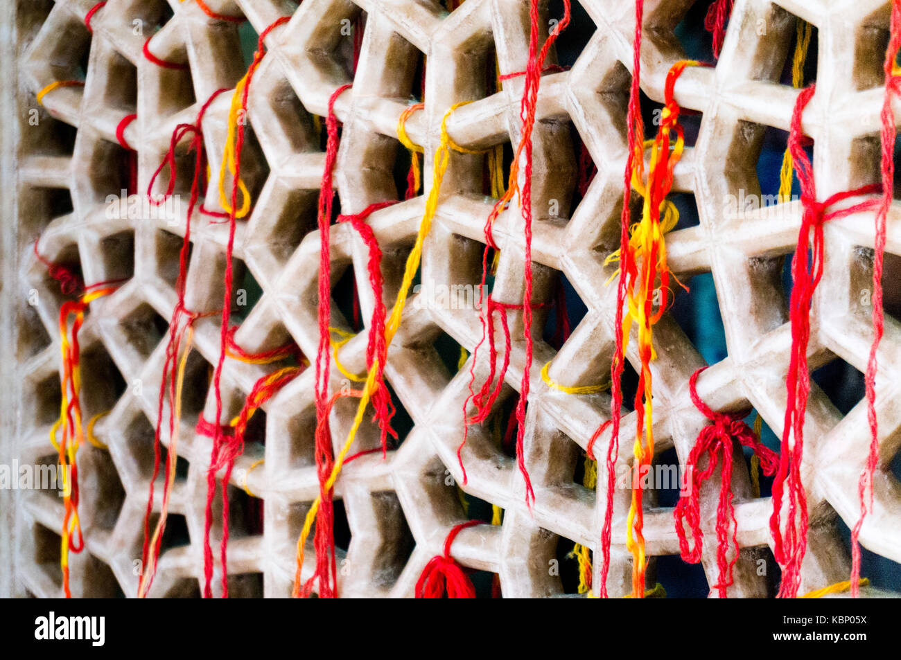 Marble mesh covered with sacred multicolored threads. These threads are ...