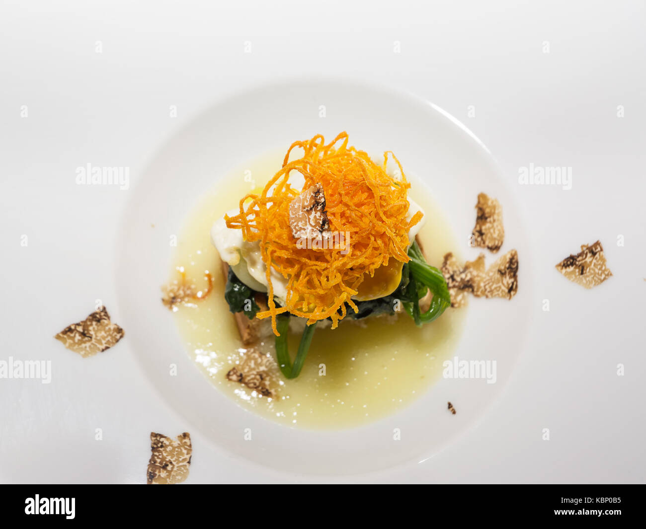 Bread cooked on fine cream of potatoes, quail egg and truffle Stock Photo
