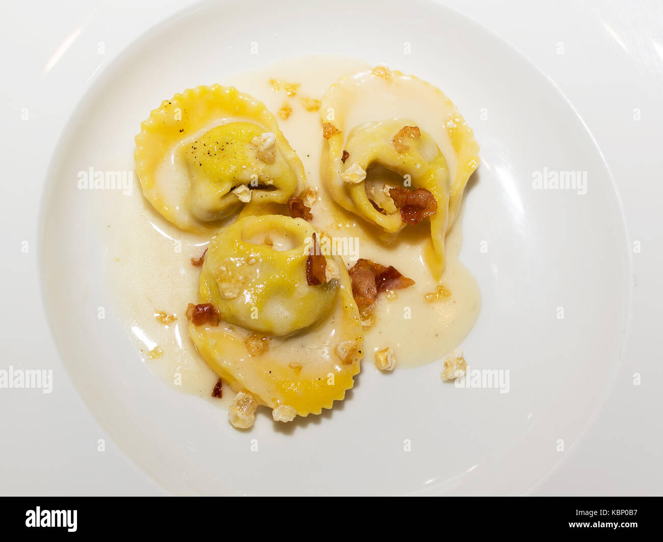 Tortelli on parmesan fondue and crunchy pig jowl Stock Photo