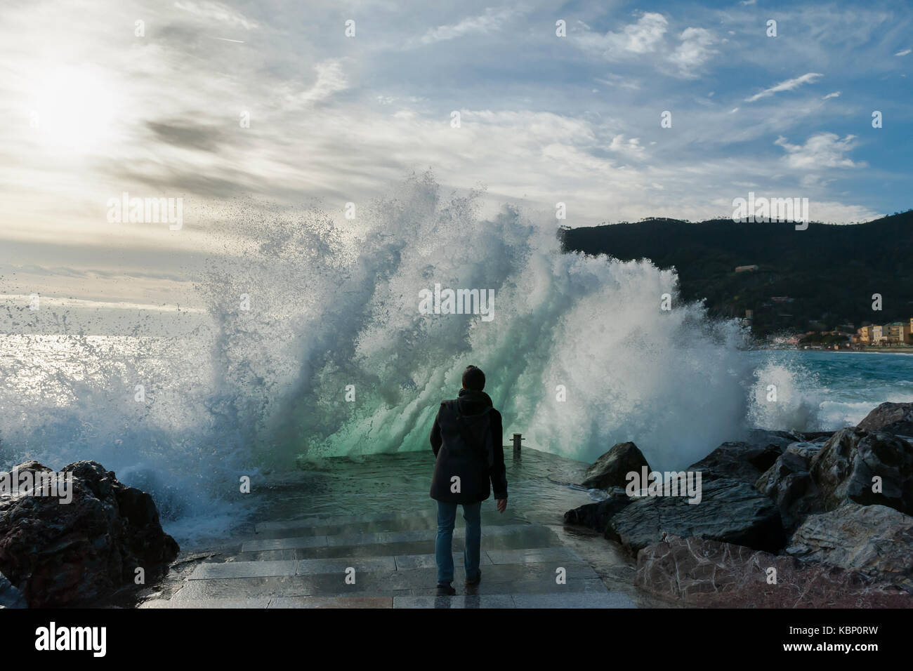Young man surrounded by the sea waves, Monterosso, 5 Terre, Italy Stock Photo