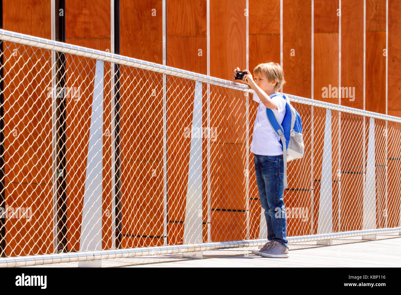 Young boy with a digital camera taking pictures outdoor Stock Photo - Alamy