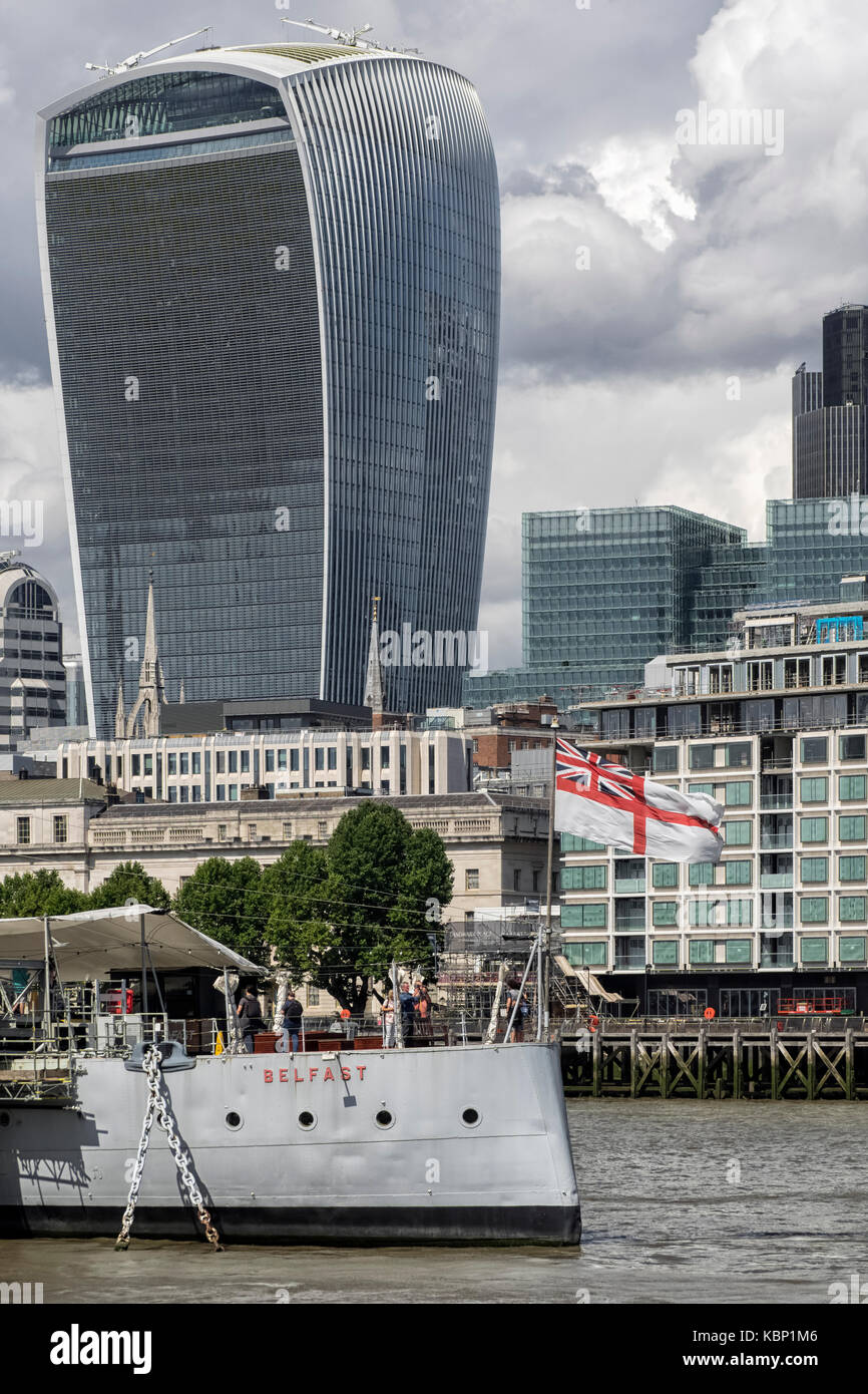 LONDON, UK - AUGUST 25, 2017:   HMS Belfast moored on River Thames with Walkie Talkie Building (20 Fenchurch Street) in Background Stock Photo