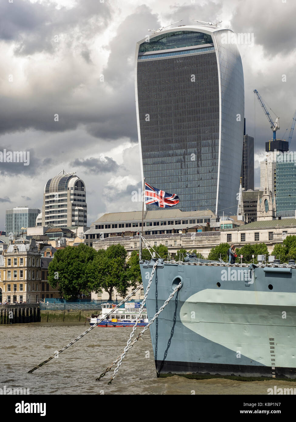 LONDON, UK - AUGUST 25, 2017:  HMS Belfast moored on River Thames with Walkie Talkie Building (20 Fenchurch Street) in Background Stock Photo