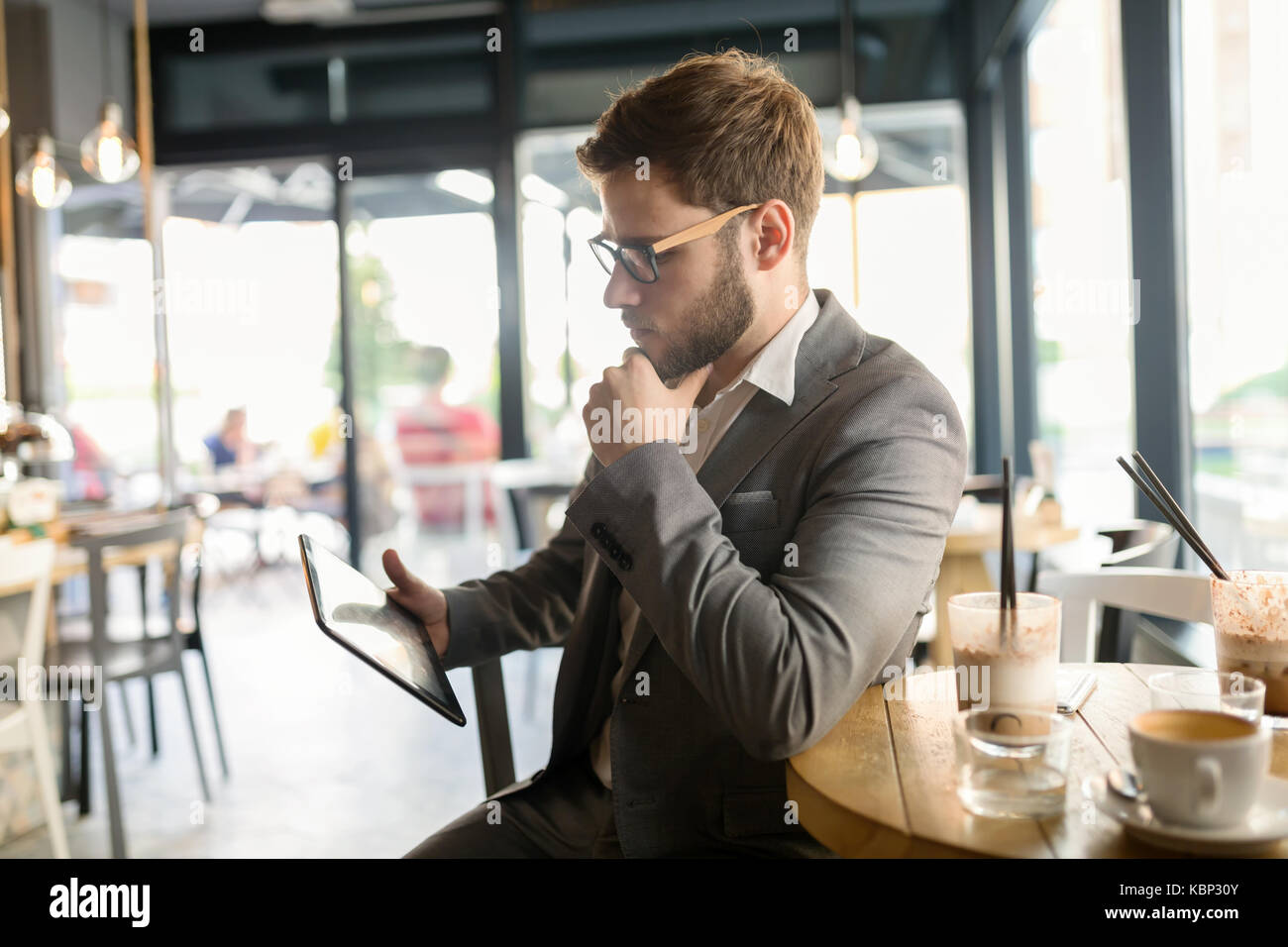 Businessman using tablet in cafe Stock Photo